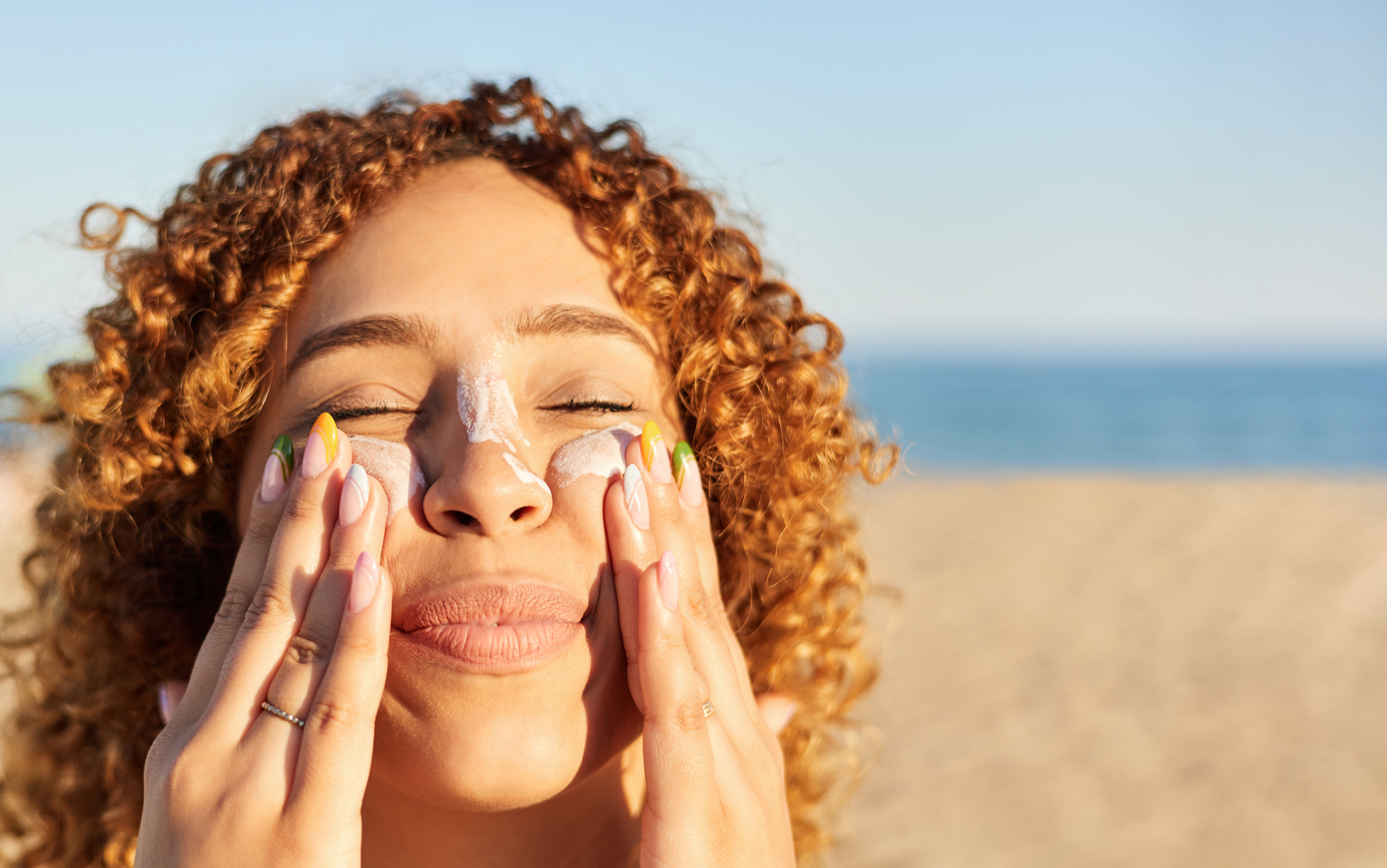 Woman Applying Sunscreen