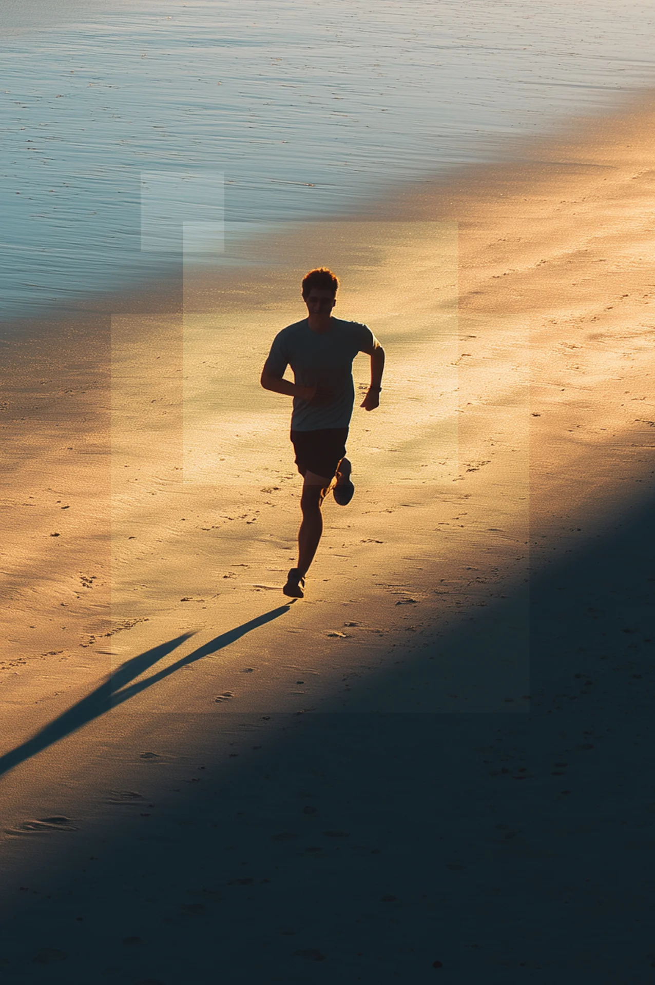 Man running on beach at sunset