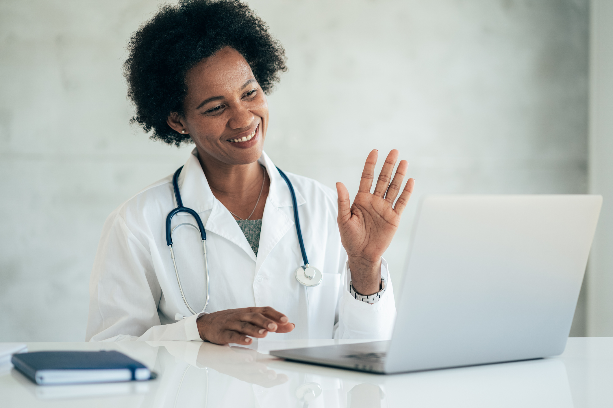 Doctor greeting patient in virtual telehealth visit