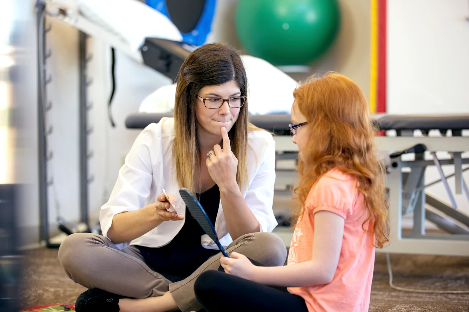 SLP performing speech therapy with child