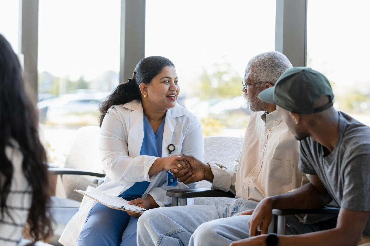 Doctor shaking elderly patient's hand