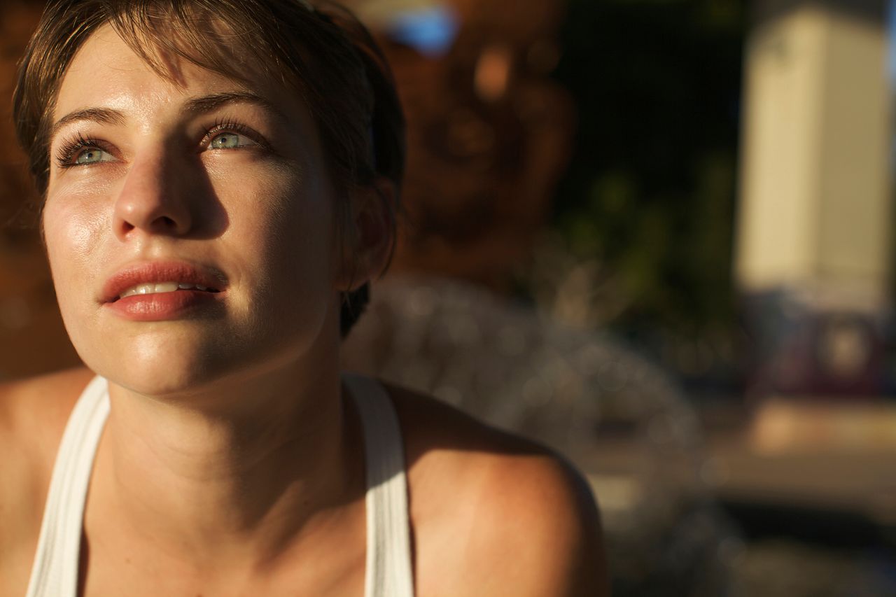 Woman with green eyes in the sun
