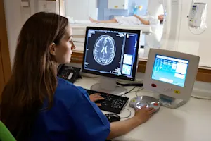 A doctor looks at a brain scan