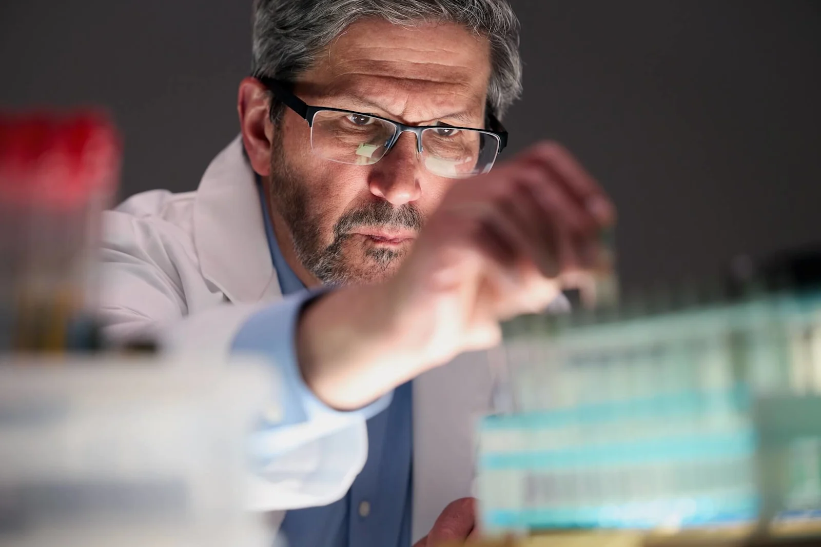 Dr. Grossman in a white coat writing on a board