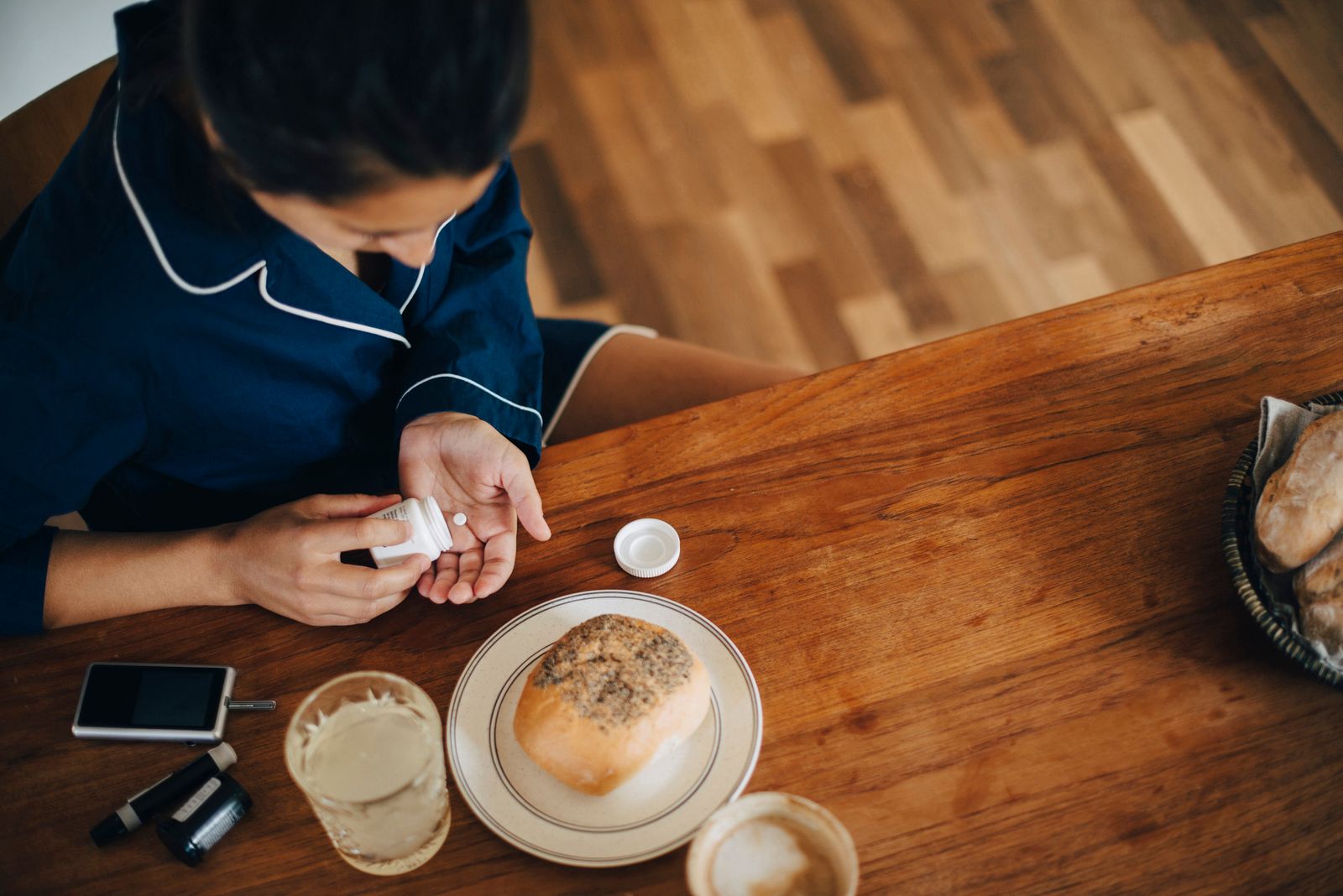 Woman taking pills with breakfast