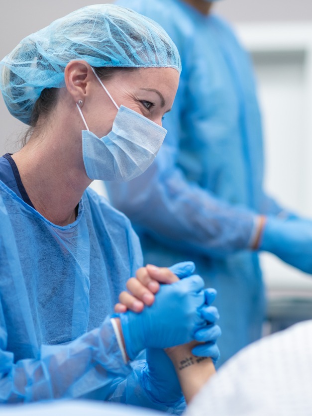 Midwife comforting woman during birth