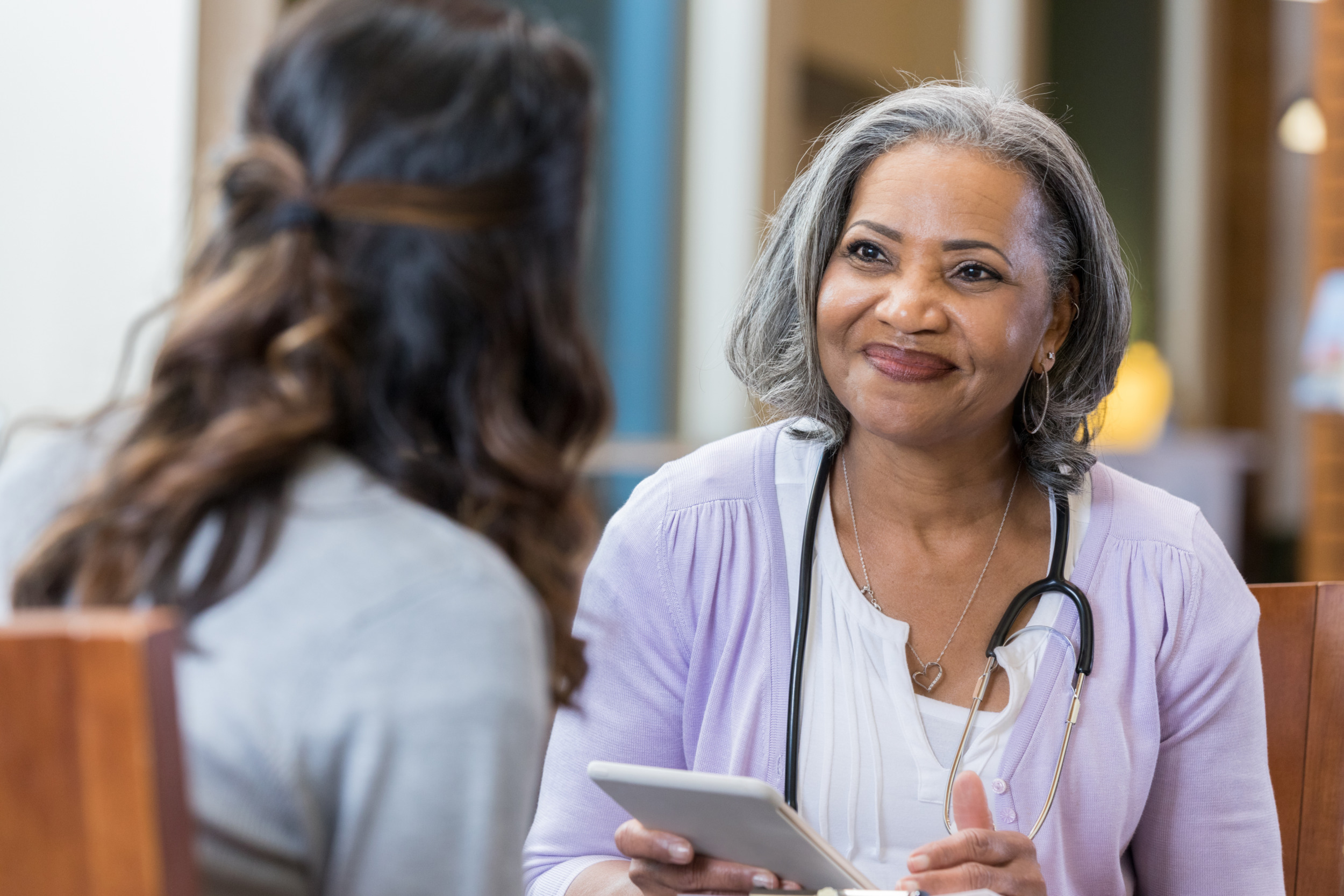 Woman talking to her smiling doctor
