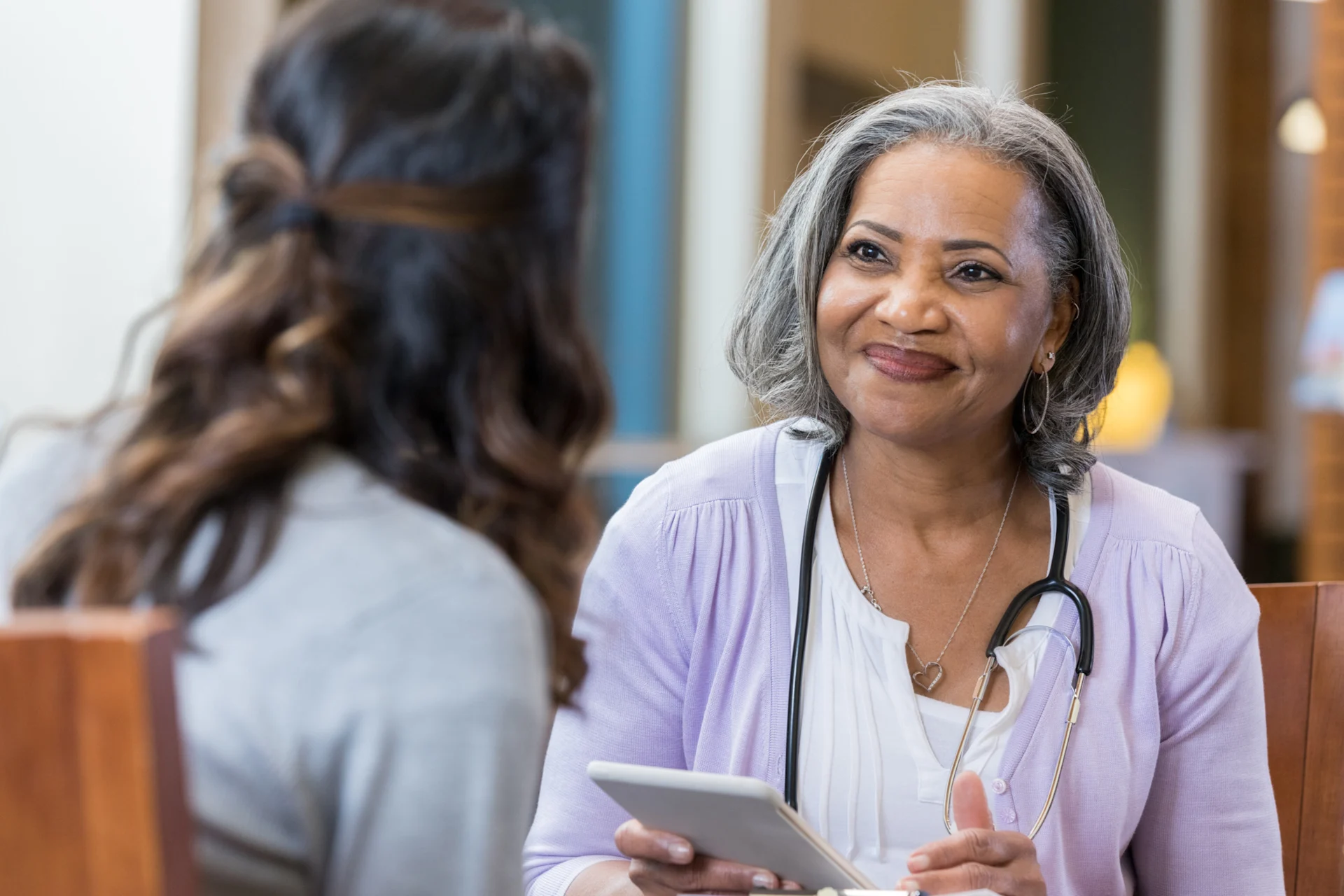 Woman talking to her smiling doctor