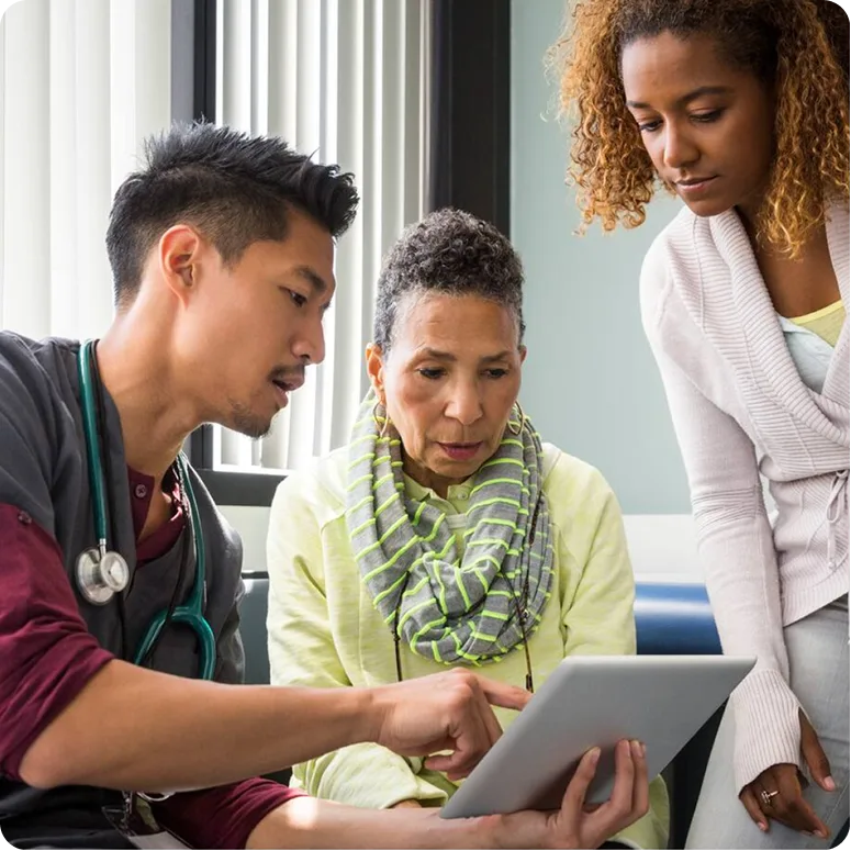 Doctor reviewing chart with patient and family