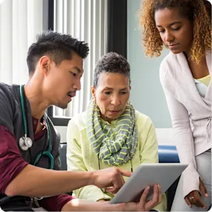 Doctor reviewing chart with patient and family