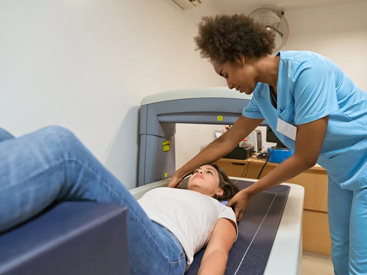 A patient prepares for an x-ray