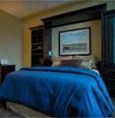 A bed in the center of a bedroom