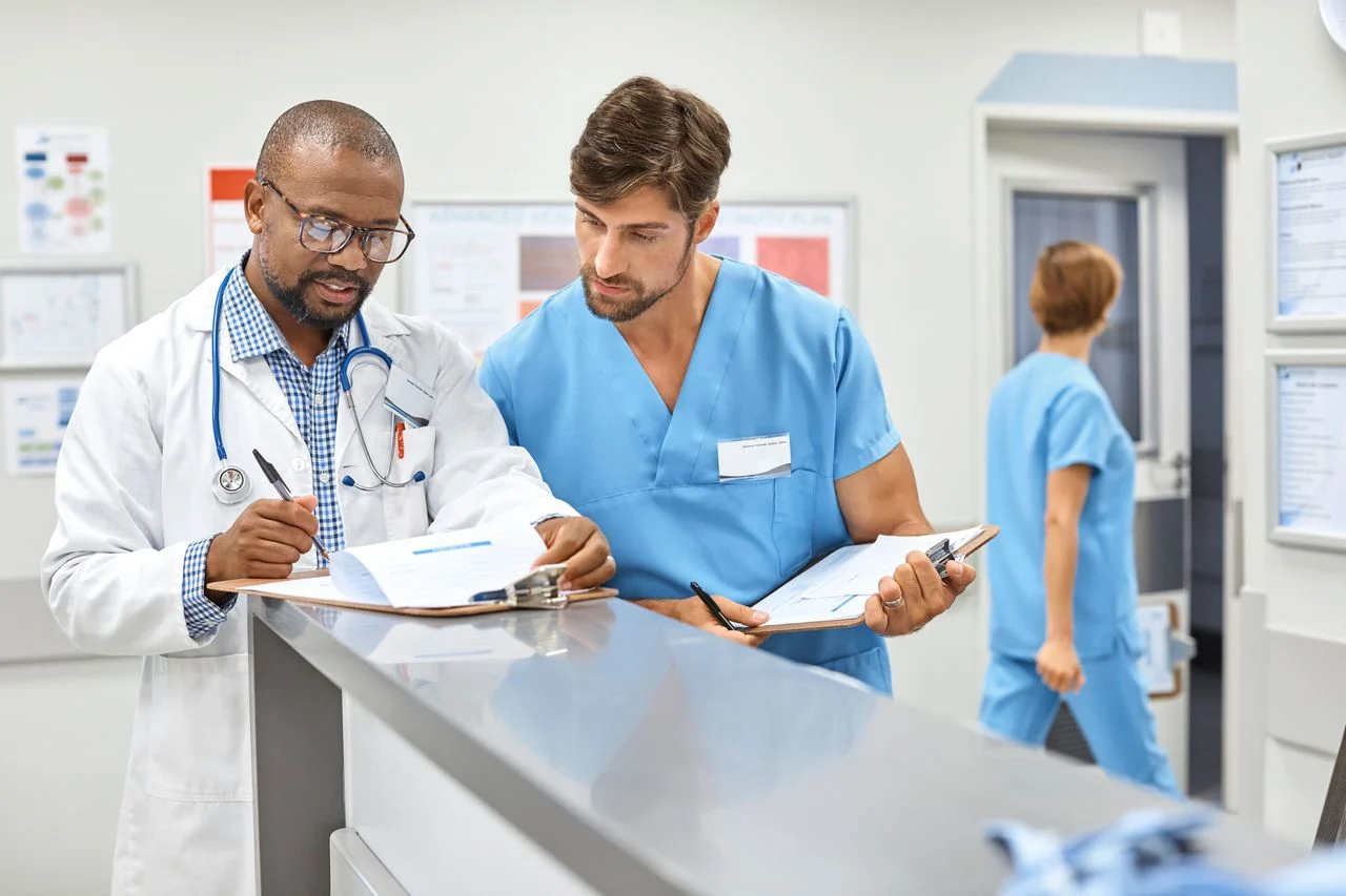 Doctor and nurse reviewing clipboards