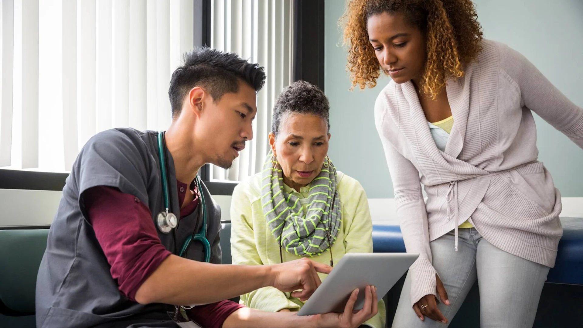 doctor showing iPad to patients