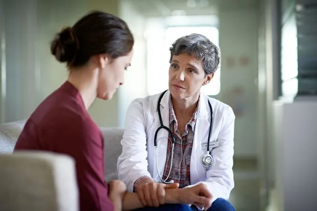 Doctor comforting patient