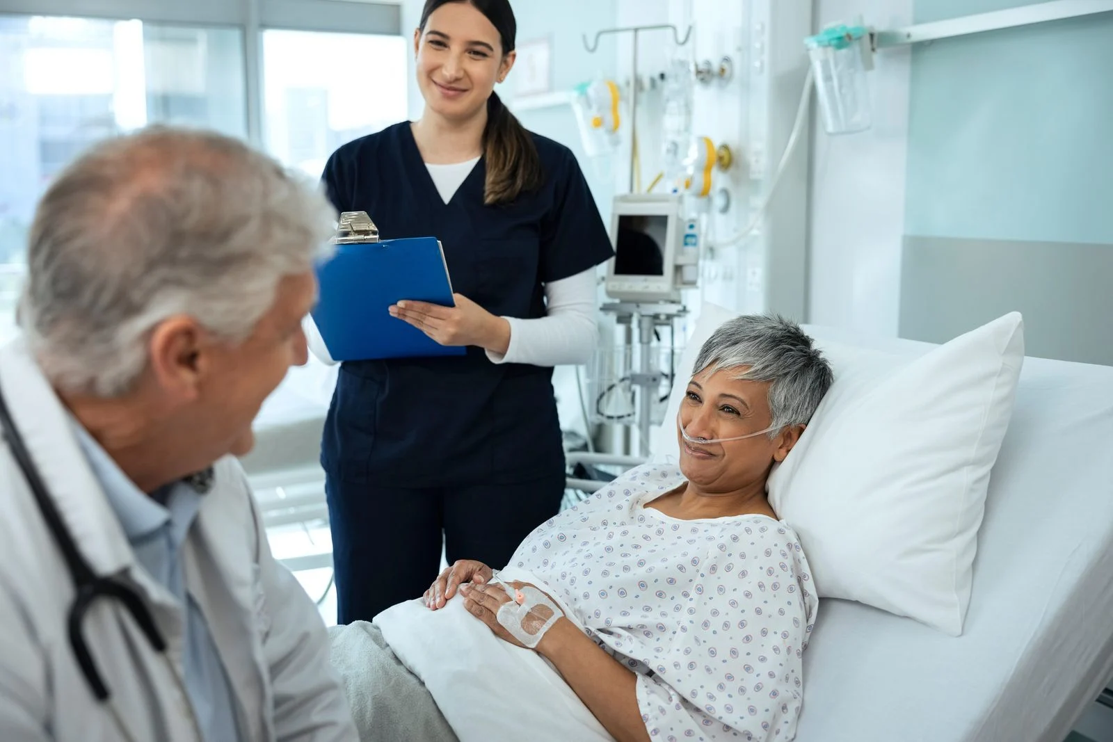 A doctor and nurse meet with a patient