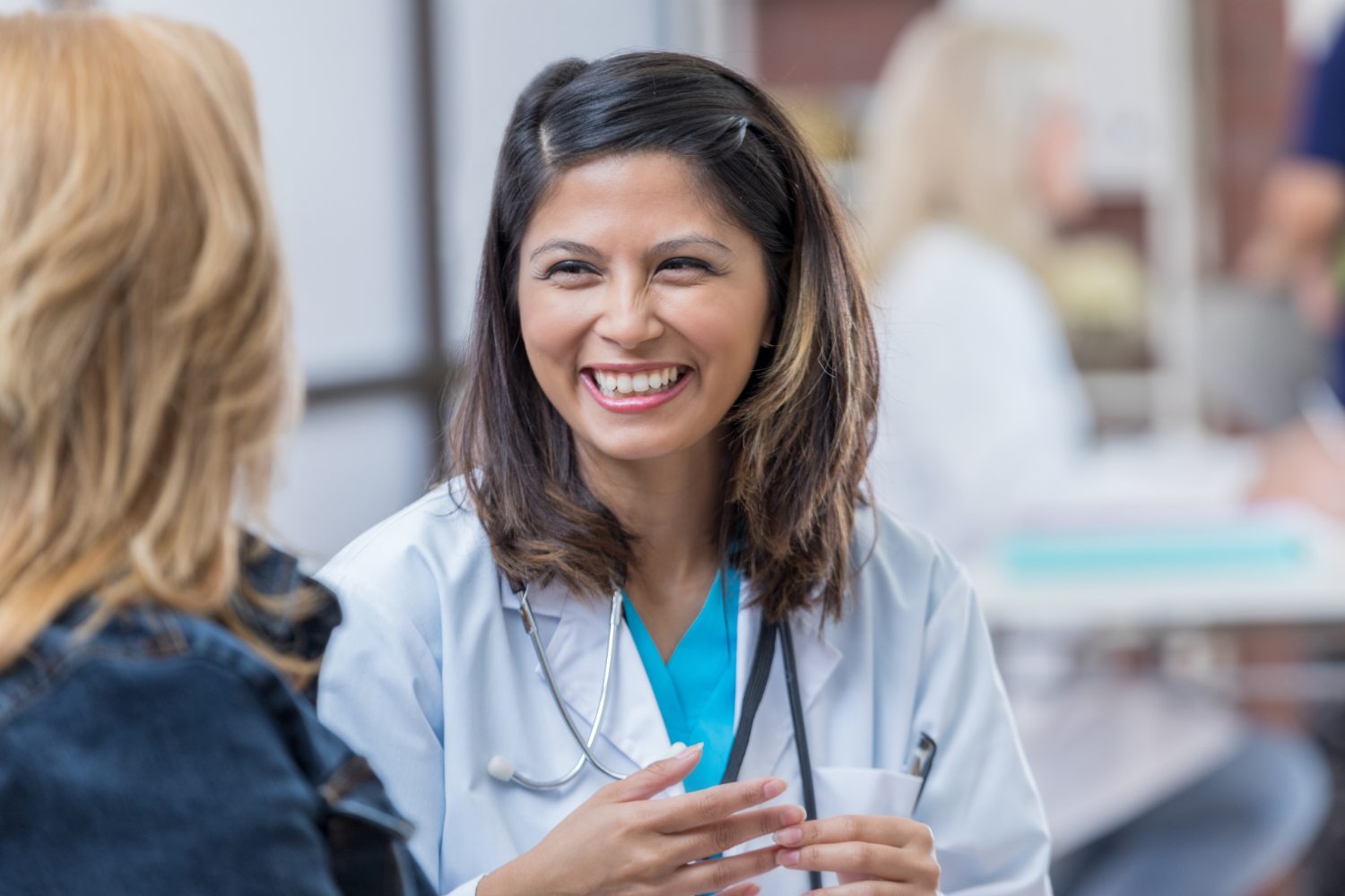 A medical assistant speaking to someone