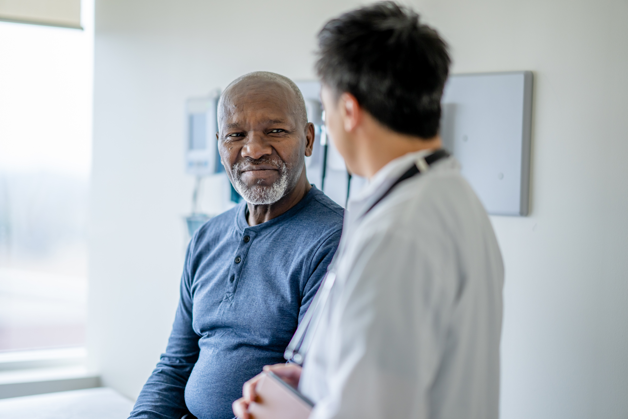 Older black man talking to doctor