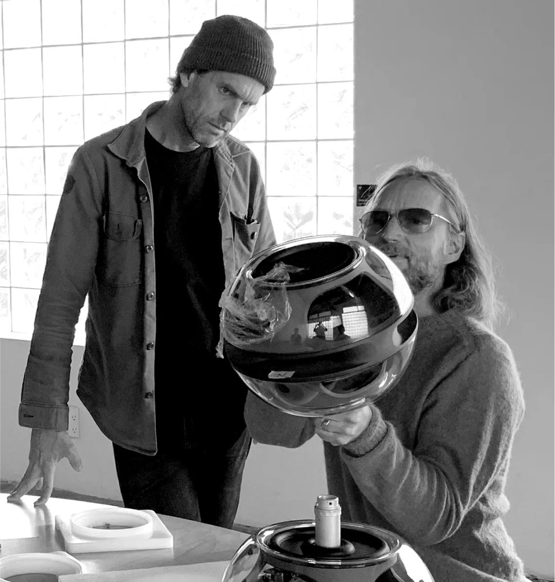 Damon Way and Christopher Stringer looking at a Syng Speaker.