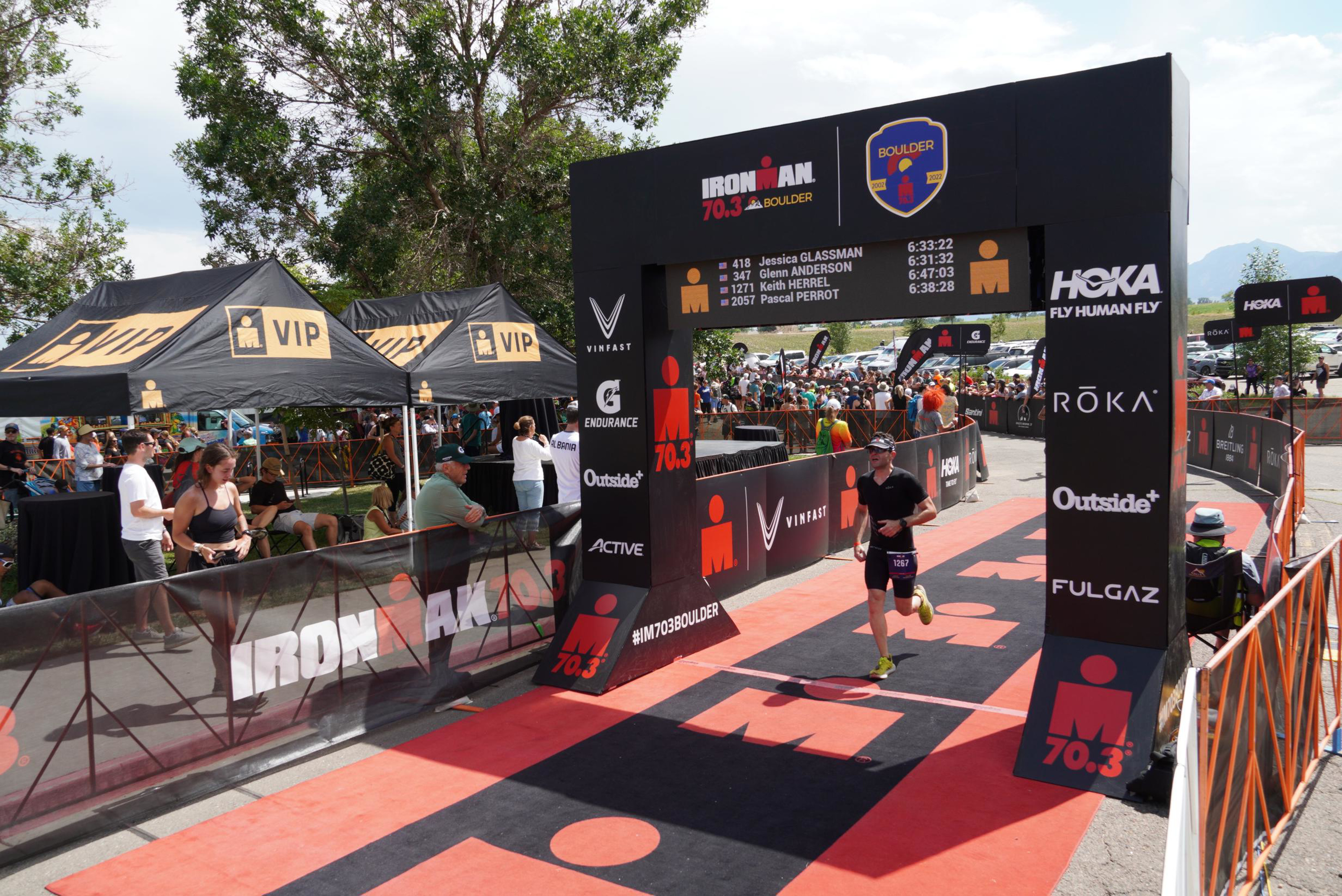 Me, crossing the finish line at Ironman 70.3 Boulder.