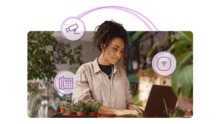 A woman with icons of a camera, wi-fi, and phone circulating around her