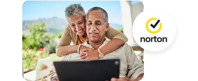Two people using a tablet outdoors, with the Norton logo displayed on the right.