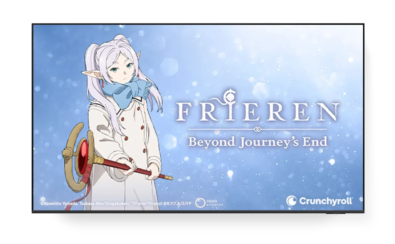 A TV screen displaying the poster for Frieren on Crunchyroll.