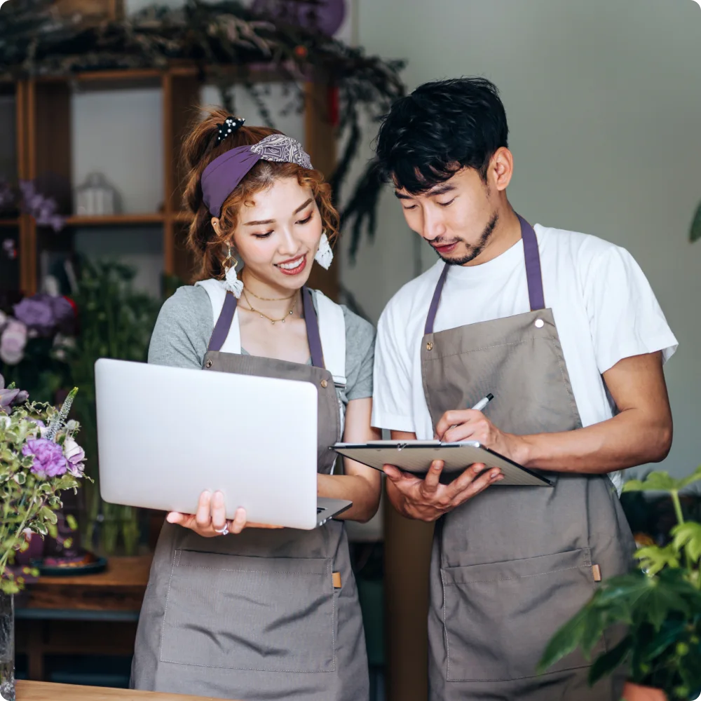 Business owners with laptop and tablet.