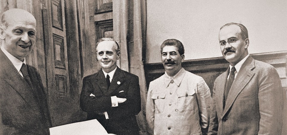 Слева направо: зав. юротделом МИД Германии Фридрих Гаусс, Иоахим фон Риббентроп, Иосиф Сталин и Вячеслав Молотов во время подписания пакта. Источник: Wikimedia Commons
