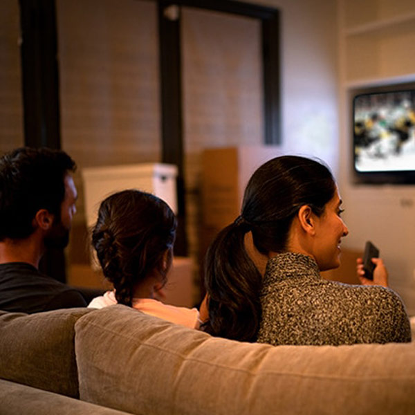 Family watching hockey game using Voice Remote