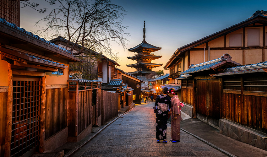 CAA MCV: Two Geishas in traditional dress walk towards a temple