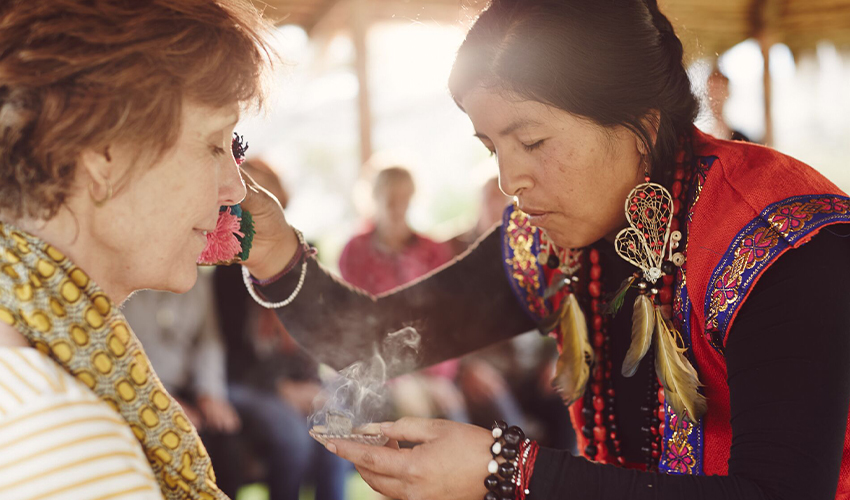 Trafalgar: Woman receiving blessing from a female Peruvian shaman