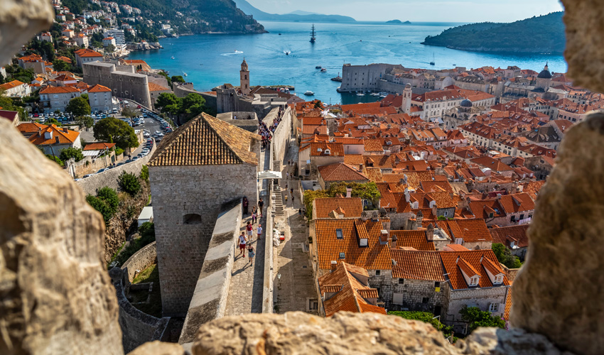 Aerial view of the red rooftops of Dubrovnik’s Old Town with the Adriatic Sea in the background