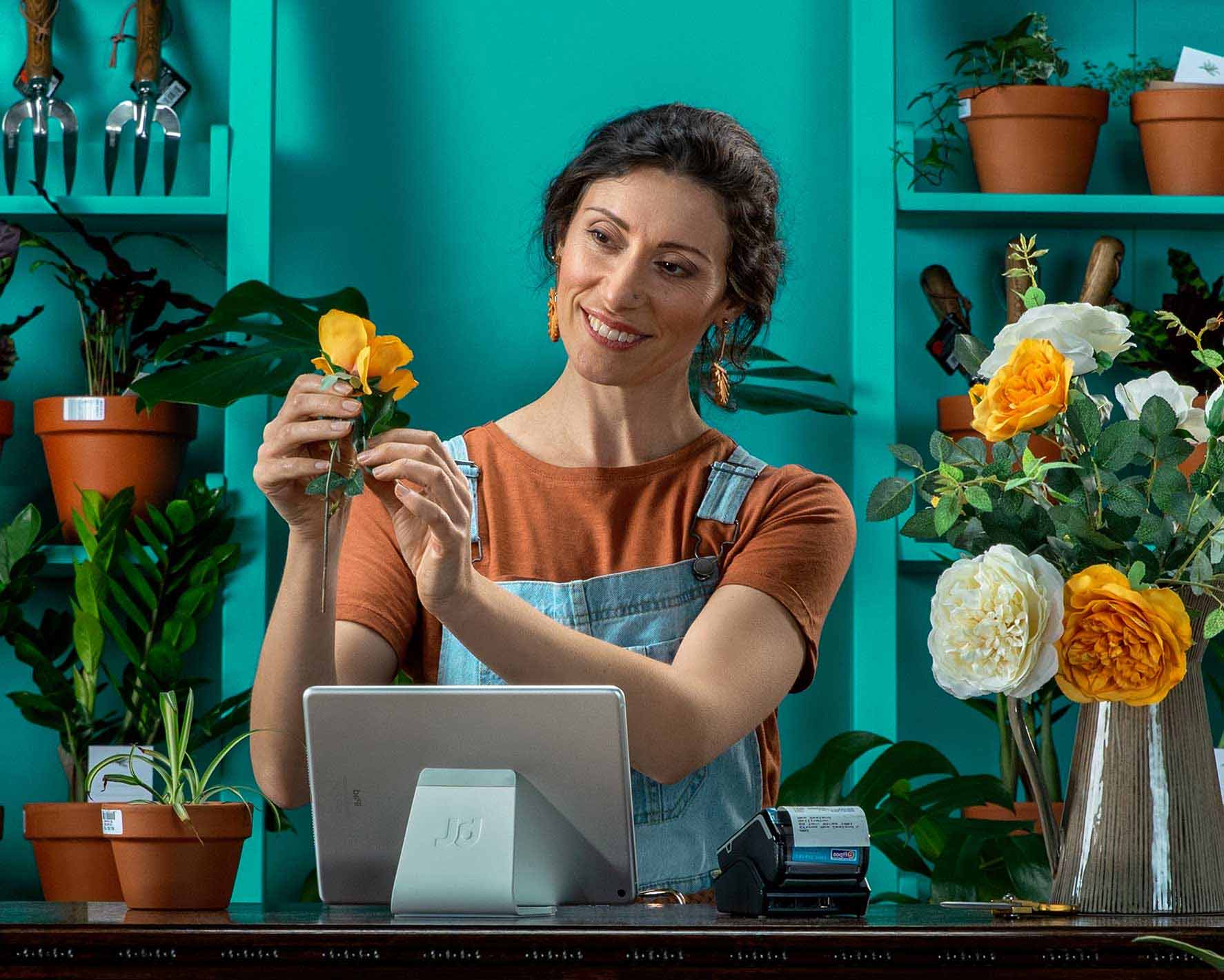 A happy florist with a POS system