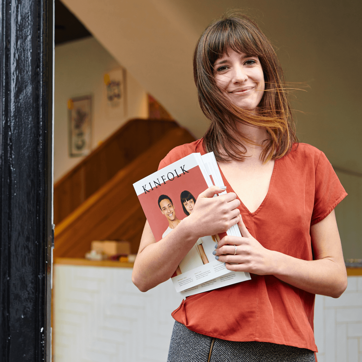 Simonie Warren, founder of Papersmiths, holding books in her store