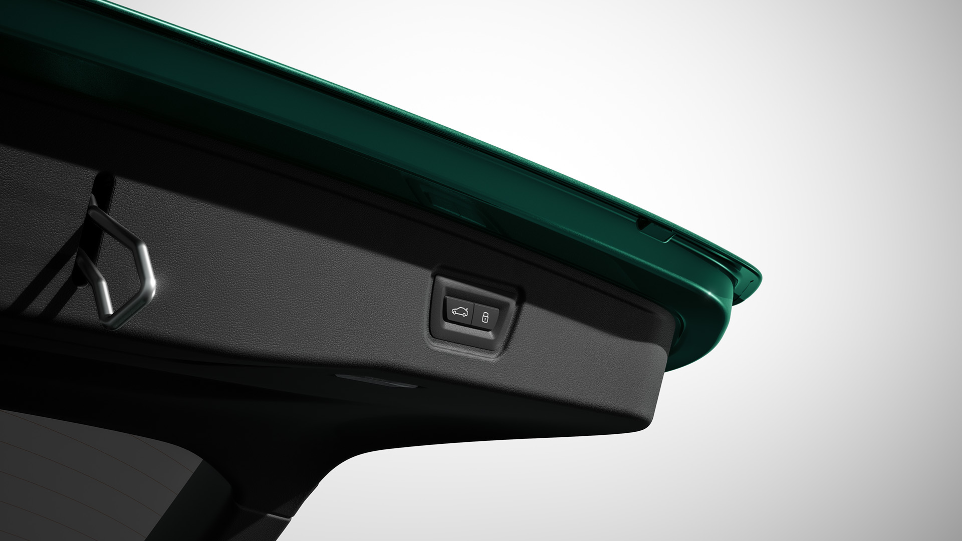 Close-up view of the interior of a car's trunk lid, showing a latch and an electronic button for automatic closing.