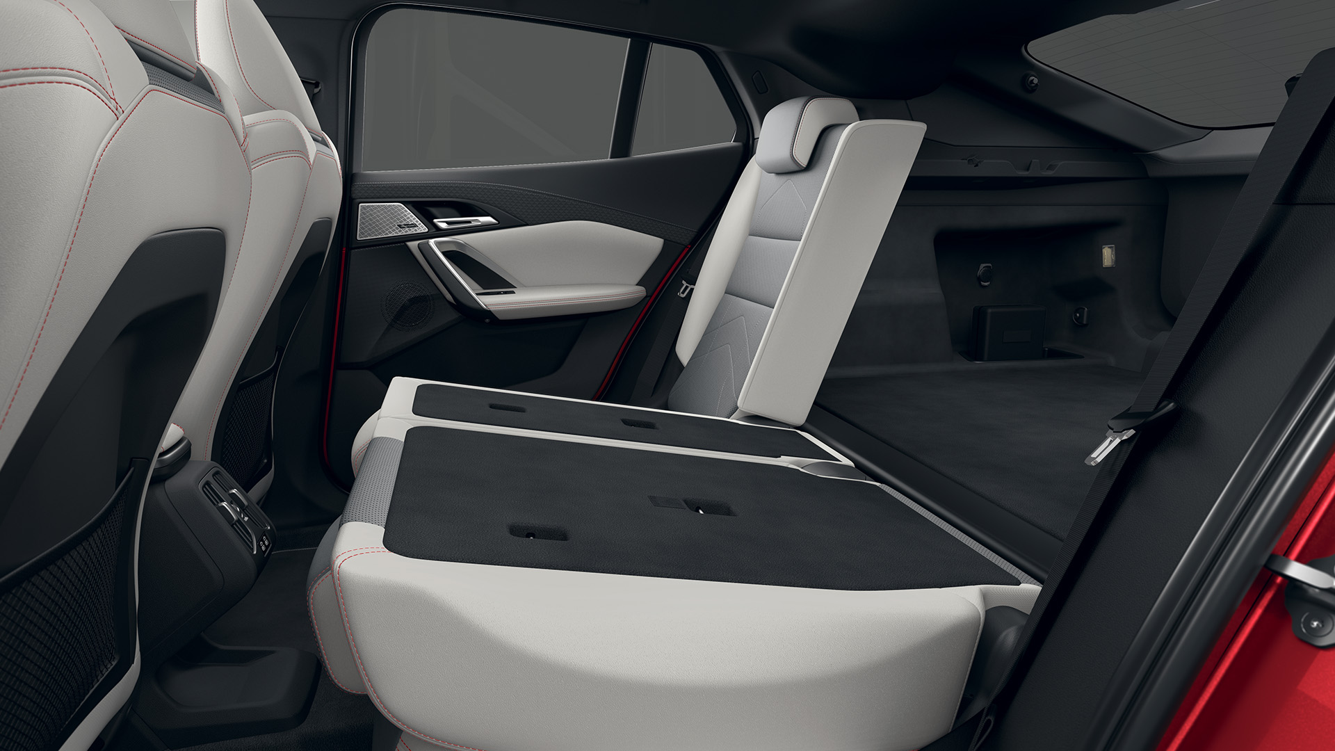 Interior view of a BMW car showing the rear seats folded down to increase cargo space.