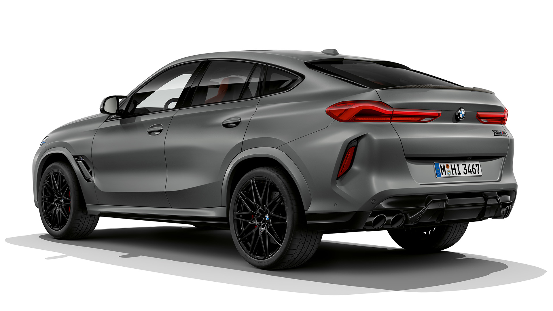 Rear view of a gray BMW X6 M SUV with black wheels and tinted windows.