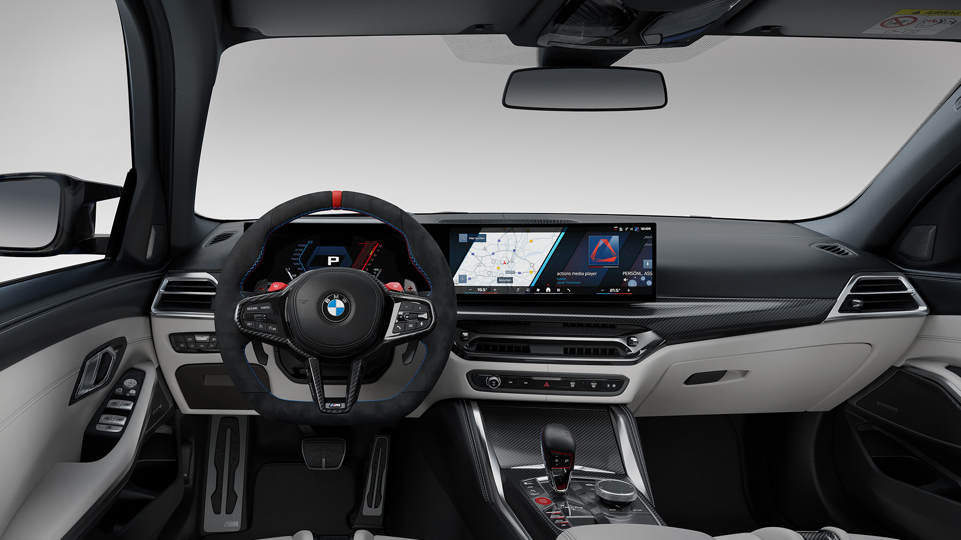 Interior view of a modern BMW car showing the steering wheel, dashboard with digital displays, and center console.