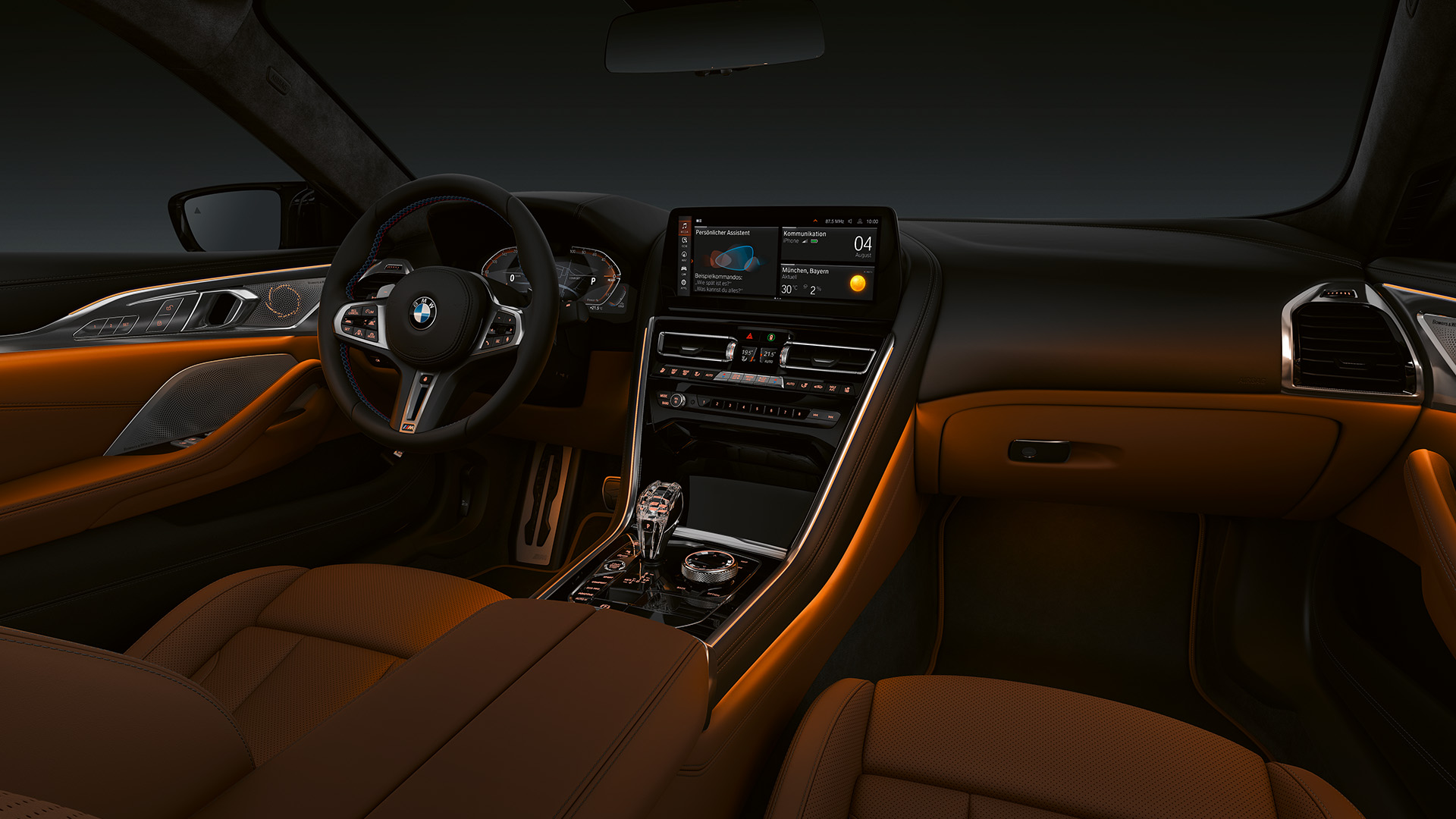 Interior view of a luxury BMW car featuring a modern dashboard with an infotainment screen, leather seats, ambient lighting, and a sleek steering wheel.