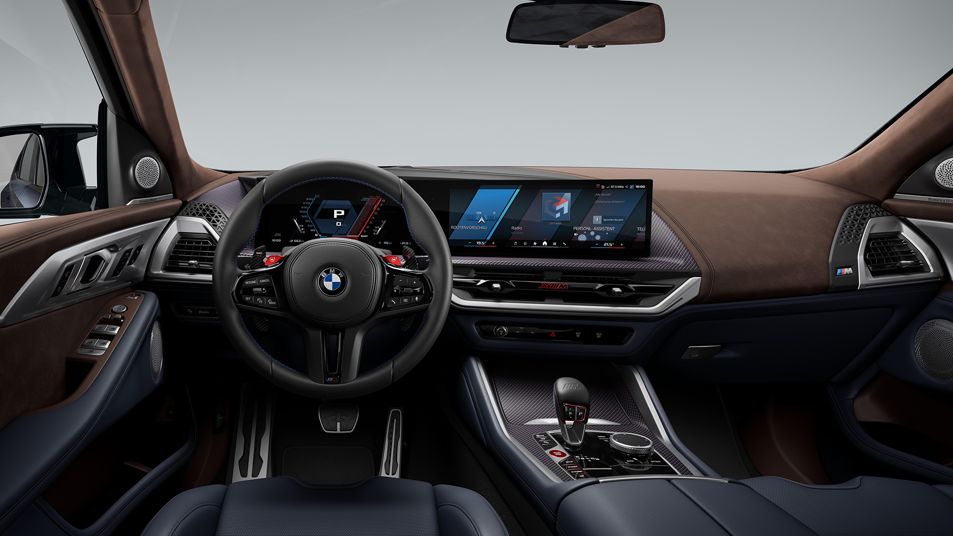 Interior view of a modern BMW car showing the steering wheel, dashboard with digital displays, gear shift, and luxurious leather seats.