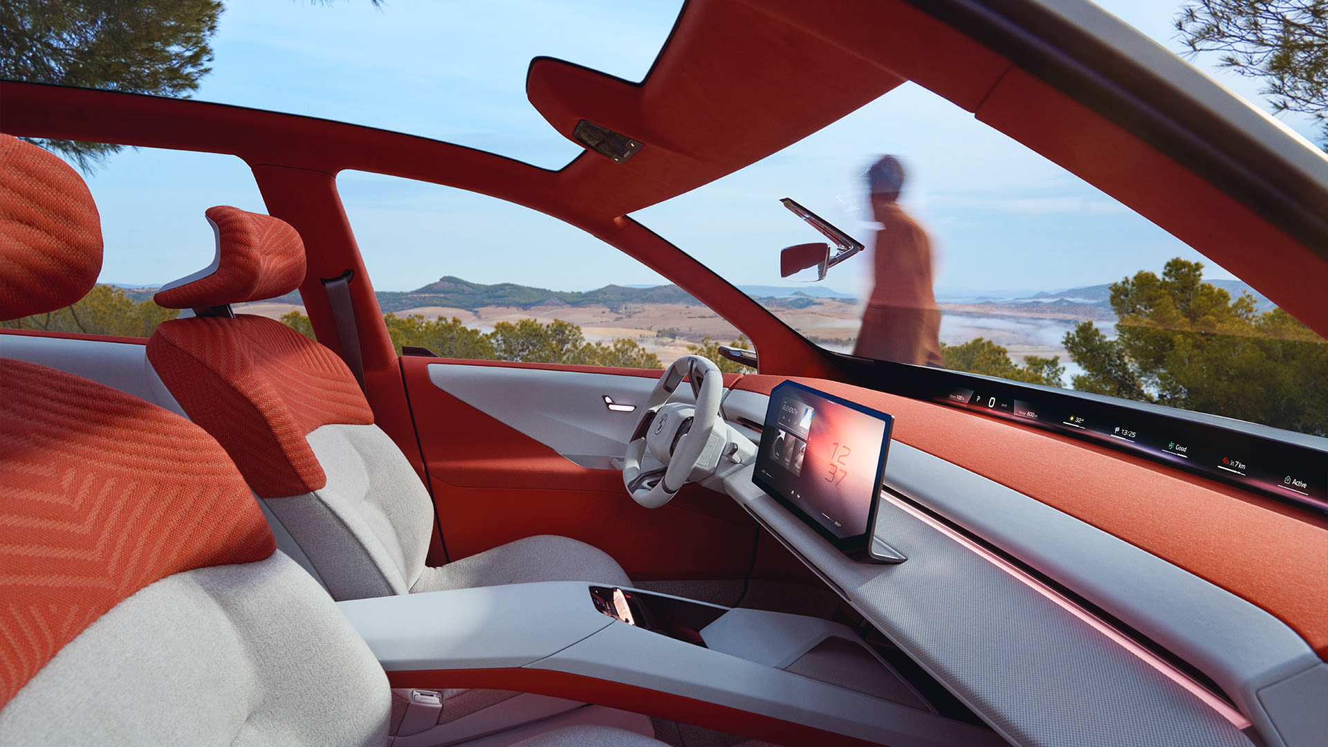 BMW luxury car interior with red and white leather seats, advanced touchscreen dashboard, and panoramic sunroof view of nature