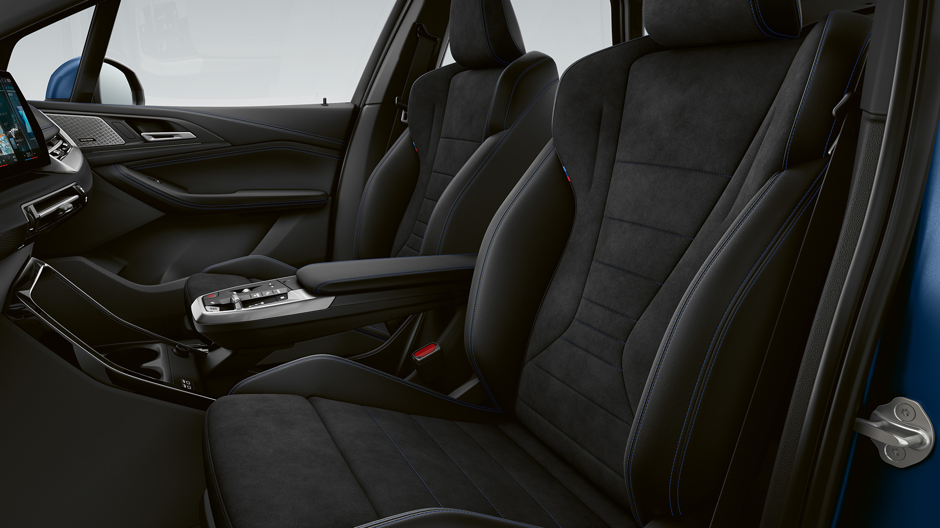 Interior of a modern car showing the front seats and dashboard, with black upholstery and sleek design elements.