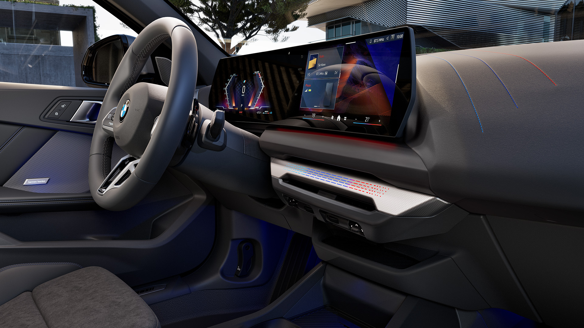 Interior view of a modern BMW car showcasing the dashboard, steering wheel, and digital display with an exterior view of a contemporary building in the background.