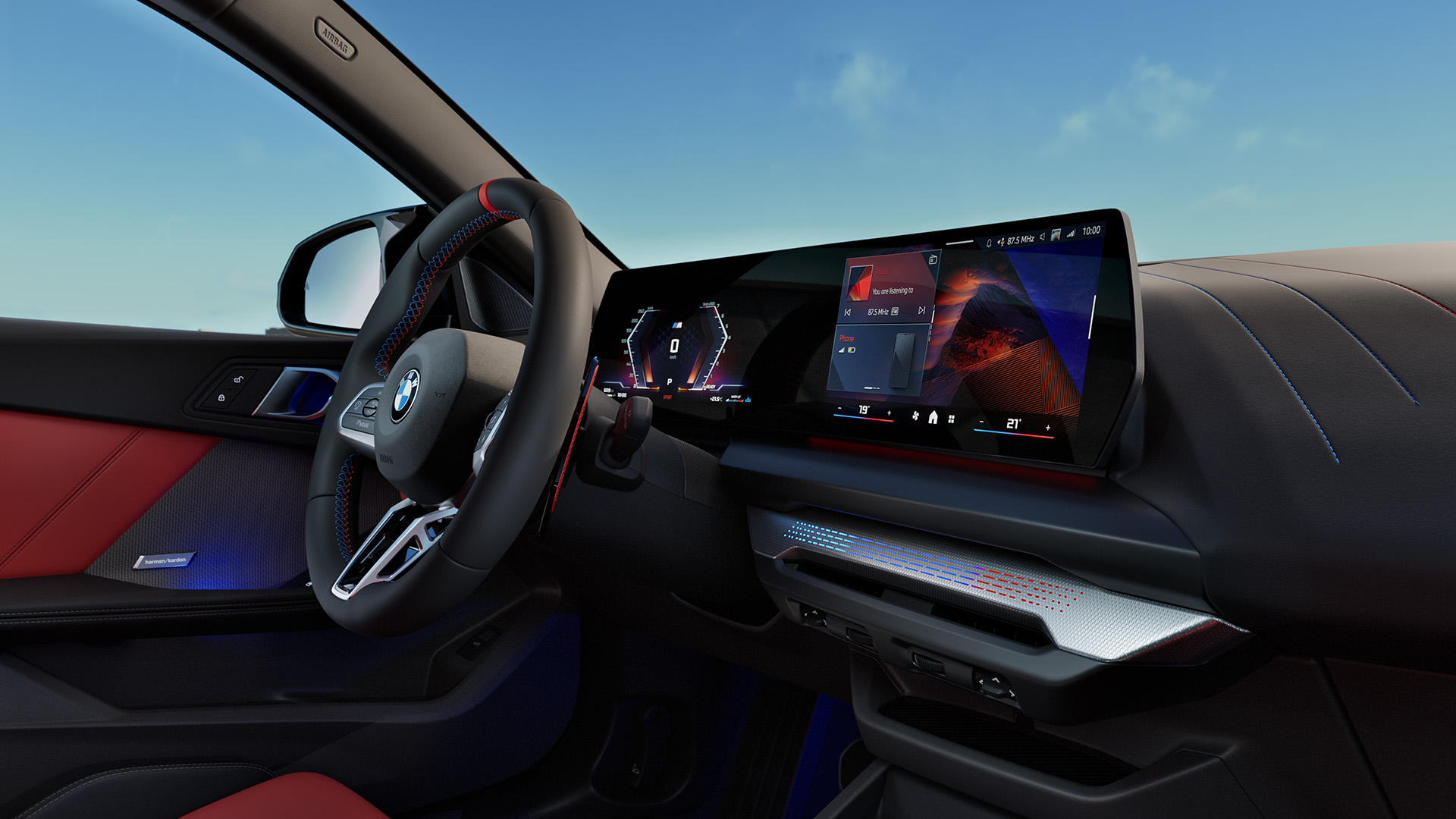 Interior of a modern BMW car showing the steering wheel, dashboard with digital displays, and red and black leather seats.