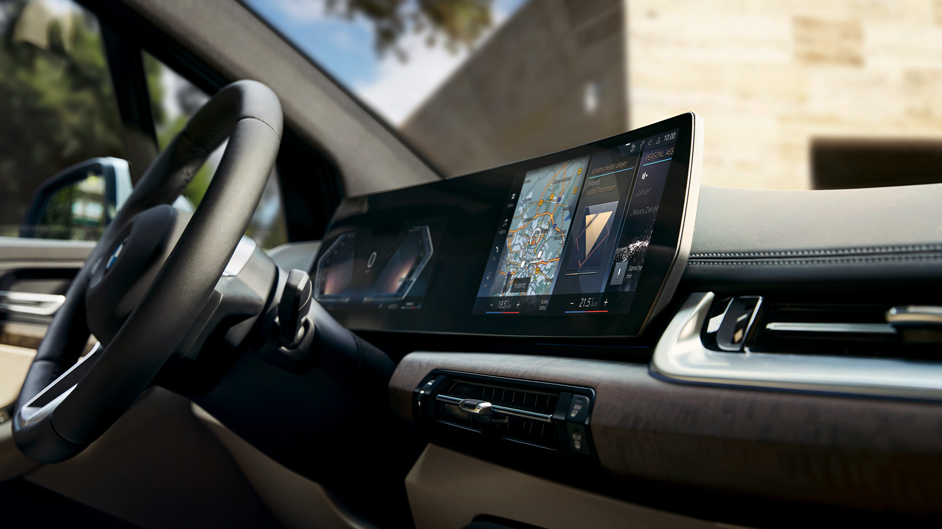 Interior of a modern car showing the steering wheel and a large digital dashboard display with navigation and various controls.
