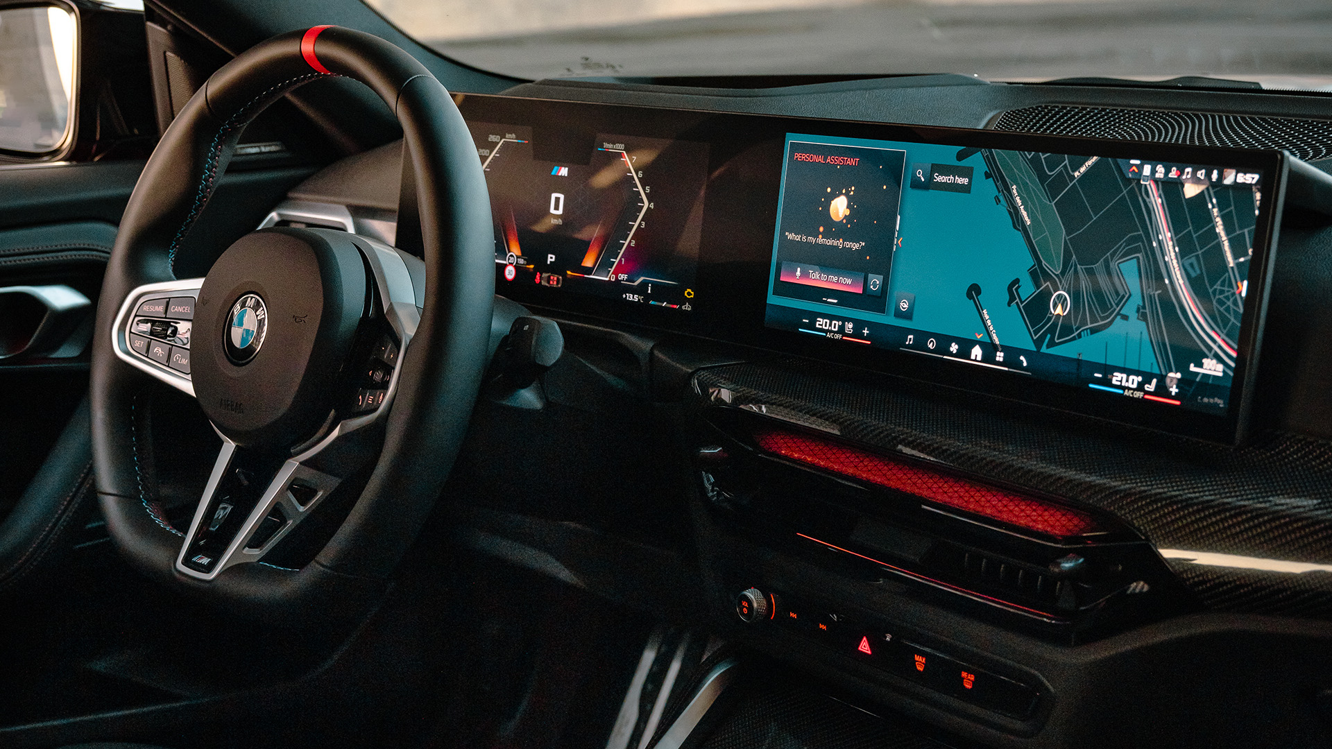 Interior of a modern BMW car showing the steering wheel, dashboard with digital displays, and center console with control knobs.
