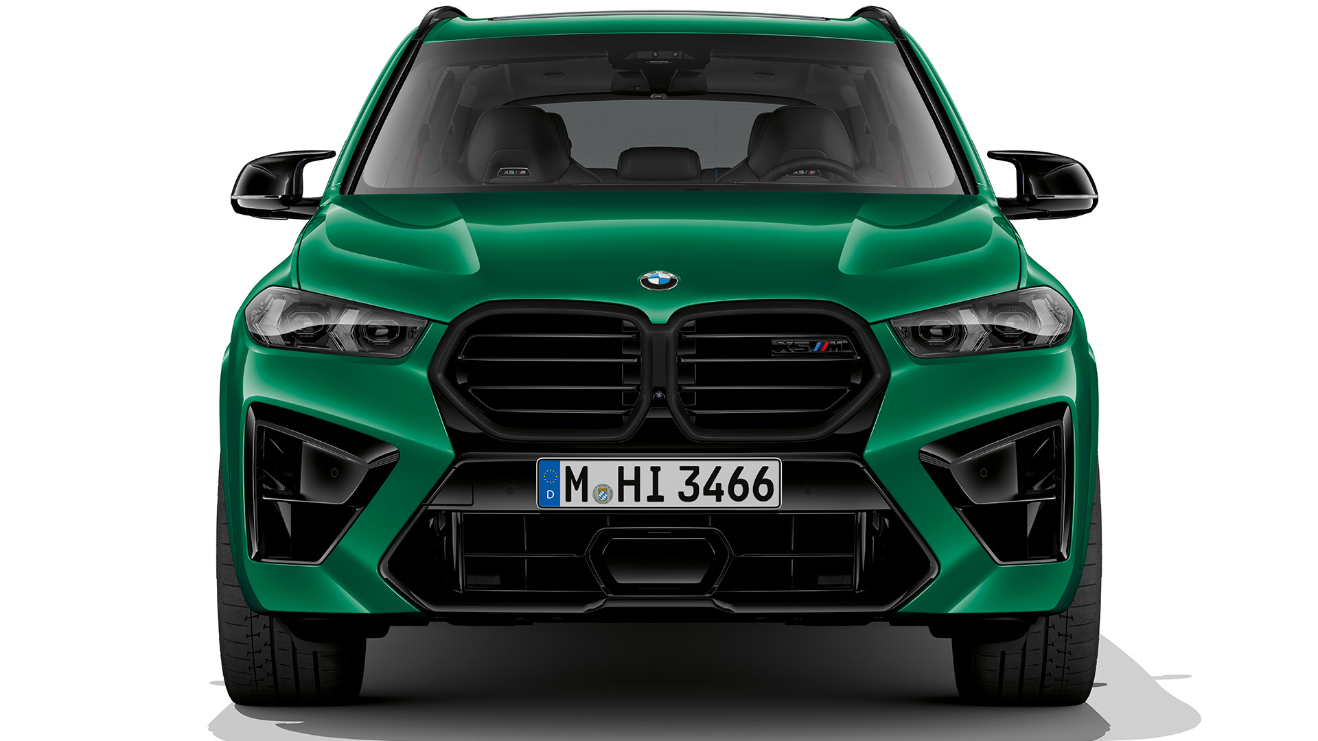 Front view of a green BMW X5 M.