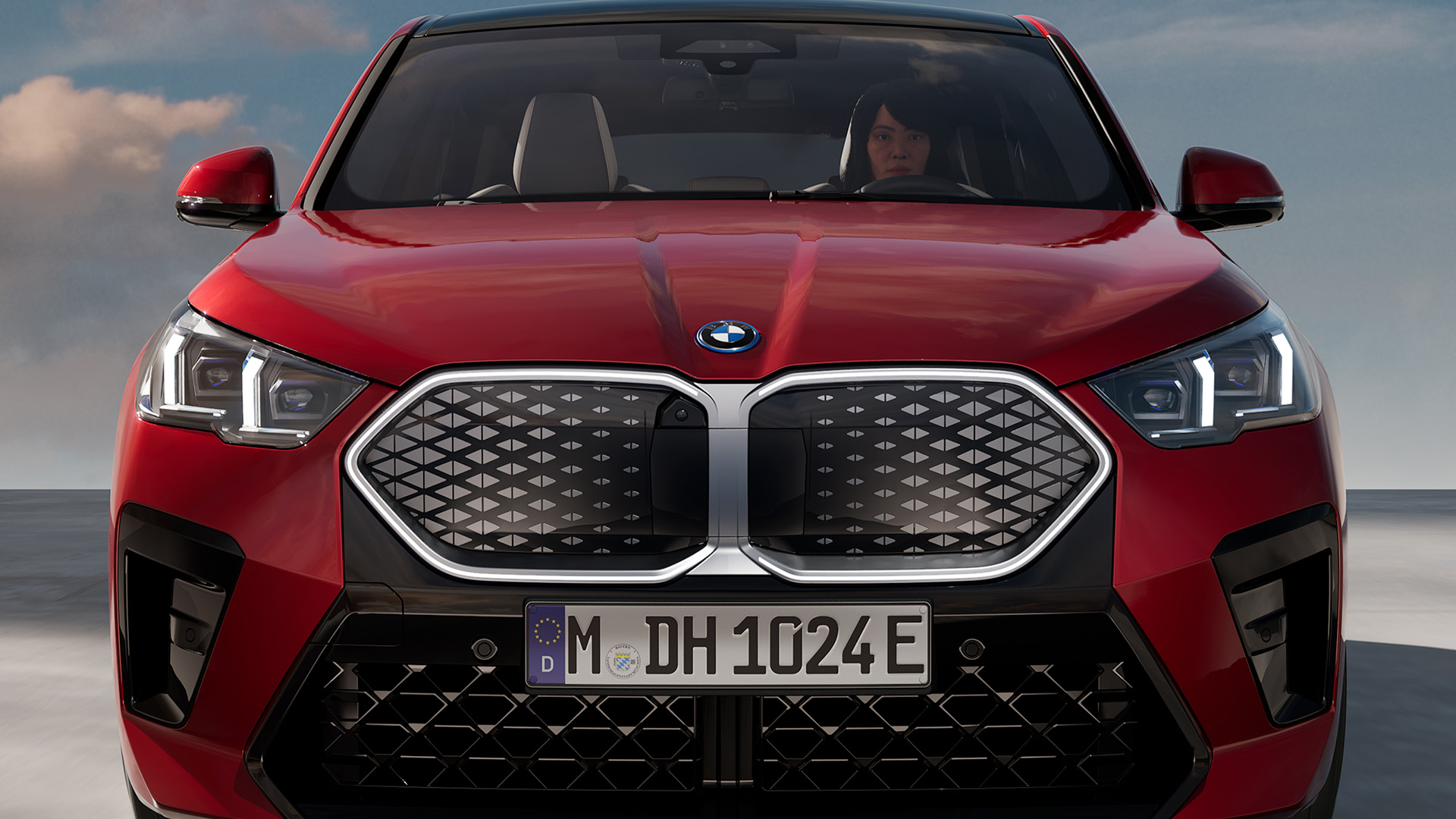 Front view of a red BMW car with a prominent grille.