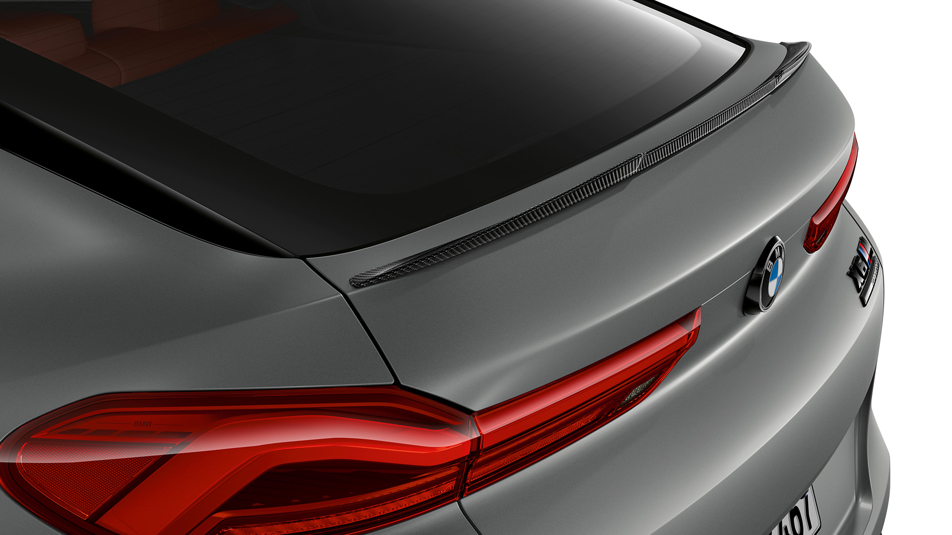 Rear view of a gray BMW car showing the taillights, rear windshield, and license plate.